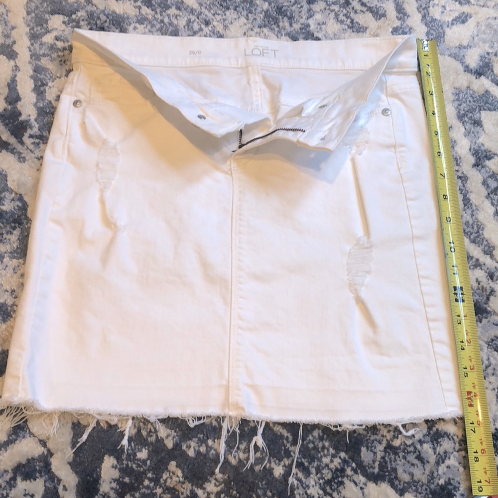 Super cute and clean, distressed mini, white denim skirt.